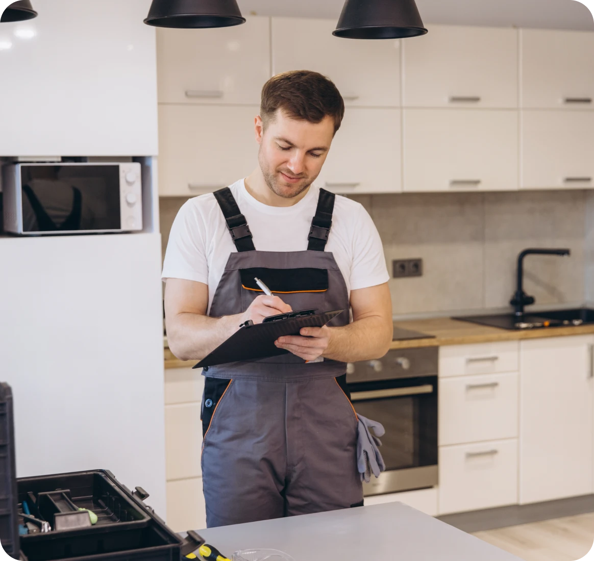 Worker taking notes in modern kitchen